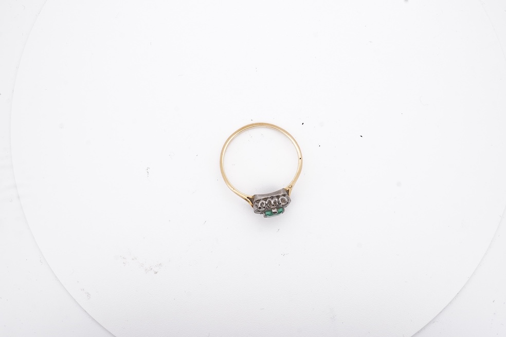 An early to mid 20th century yellow metal, emerald and diamond set rectangular cluster ring, size R, gross weight 3.5 grams. Condition - poor to fair